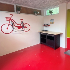 Blue ping pong table with a colorful painting in the background